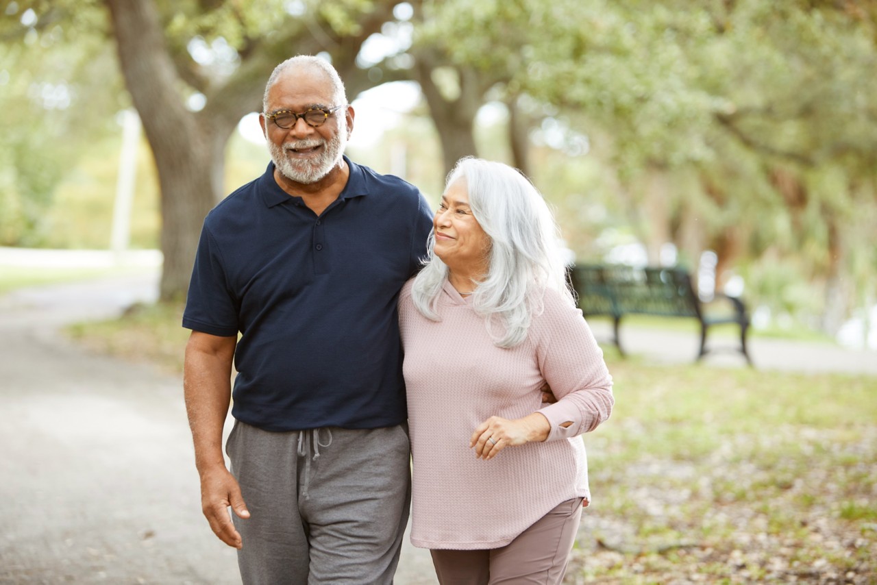 Senior couple walk together in the park